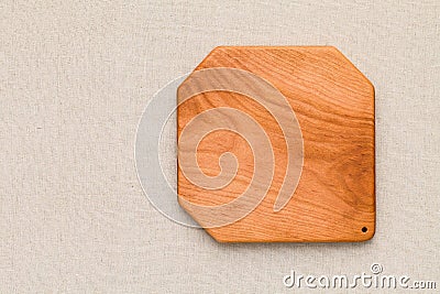Handmade cherry wood wooden chopping board on sackcloth. Cherrywood wooden pallet. Cherry wood plank natural texture background. Stock Photo