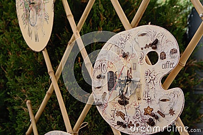 Handmade clocks in different shapes at the market Editorial Stock Photo