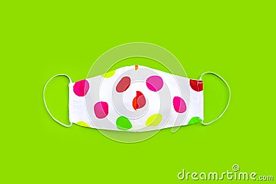 Handmade colorful cloth mask on green background Stock Photo