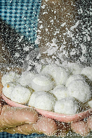 handmade condensed milk popcorn in a bowl, coconut powder falling into bowl Stock Photo