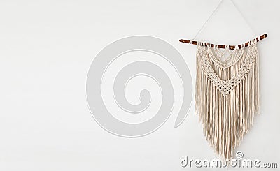 Handmade 100 cotton macrame wall decor hanging on a white wall Stock Photo