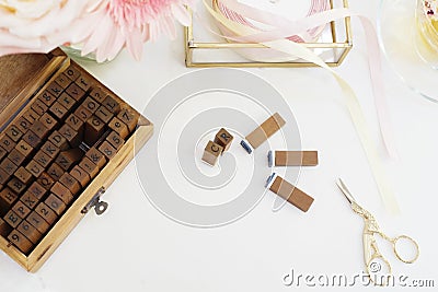 Handmade, craft concept. Wooden rubber stamps, golden scissors, ribbons. Feminine workplace concept. Freelance fashion femininity Stock Photo