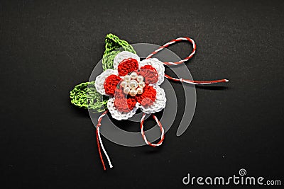 Handmade crocheted flower with red and white string, known as Martisor. Stock Photo