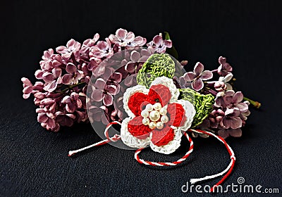 Handmade crocheted flower with red and white string, known as Martisor. Stock Photo