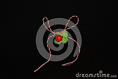 Handmade crocheted four-leaf clover with ladybug and red and white string, known as Martisor. Stock Photo