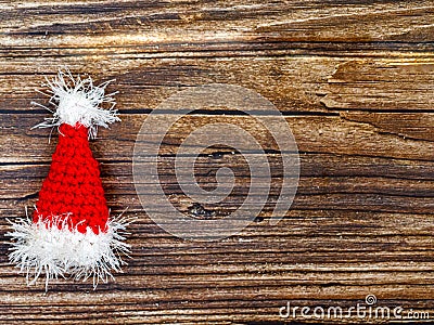 Handmade crocheted Santa hat on wooden table with copy space, top view flat lay Stock Photo