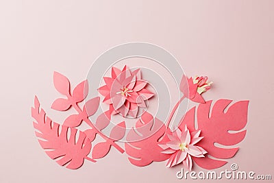 Handmade decorative paper pattern from tropical monochrome flower leaves on a pastel pink background with copy space. Top view. Stock Photo