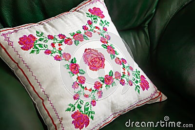 Handmade decorative pillow with rose embroidery. Stock Photo