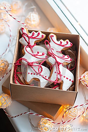 Handmade deer shaped gingerbread cookies in the carton box on the windowsill Stock Photo