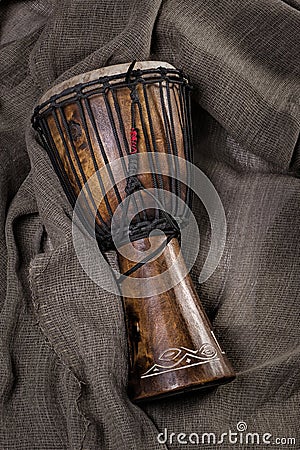 African djembe drum hand carved lying on canvas fabric Stock Photo