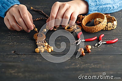 Handmade earrings making, home workshop. Woman artisan create tassel jewelry. Art, hobby, handicraft concept Stock Photo