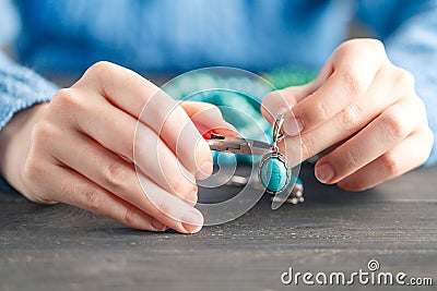 Handmade earrings making, home workshop. Woman artisan create tassel jewelry. Art, hobby, handicraft concept Stock Photo