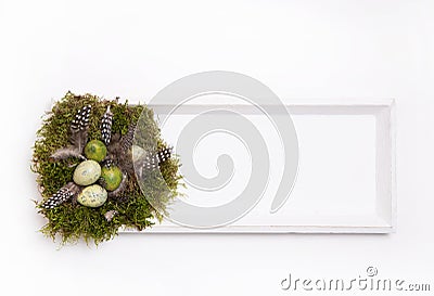 Handmade Easter nest on wooden sign or frame in natural brown Stock Photo