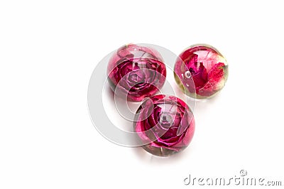 Handmade epoxy resin jewelry. roses in sphere, three pieces. top view. dried flowers. herbarium, oshibana. Stock Photo