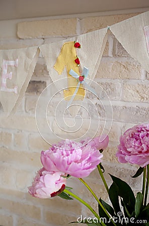 Handmade fabric garland with number one and bouquet of peonies Stock Photo