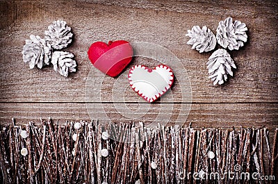 Handmade from felt hearts on wooden background. Craft arranged from sticks, twigs, driftwood and pine cones white and shiny. Stock Photo