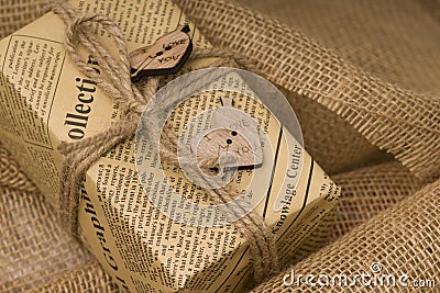 Handmade gift box with a natural rope and two wooden hearts on sackcloth, Valentines Day background Stock Photo