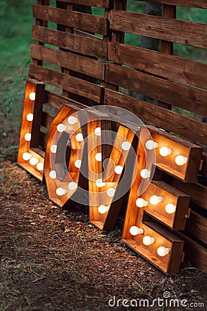 Handmade glowing love letters. modern wedding decoration outdoors Stock Photo