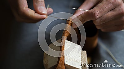Handmade handicraft leather bag sewing process. Hands working leather Stock Photo