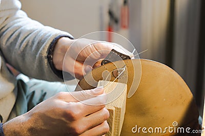 Handmade handicraft leather bag sewing process. Glue working with leather Stock Photo