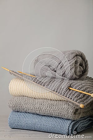 Handmade, knitting and woolen thread. Pile of knitted clothes bl Stock Photo