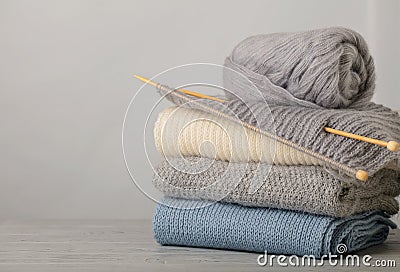 Handmade, knitting and woolen thread. Pile of knitted clothes bl Stock Photo