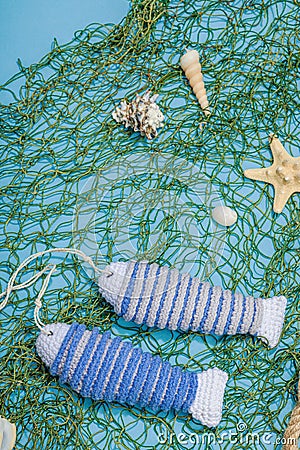 Handmade marine background. Crocheted sardine fishes, nautical style. Fishing net, sea decor Stock Photo