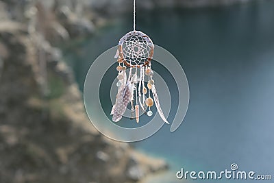 Handmade native american dream catcher on background of rocks an Stock Photo