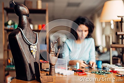 Handmade necklace on wooden mannequin, needlework Stock Photo