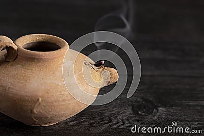 A Handmade Oil Lamp with a Smoldering Wick Stock Photo