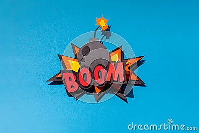 Paper comic speech bubble on blue background. Boom. Bomb. Stock Photo