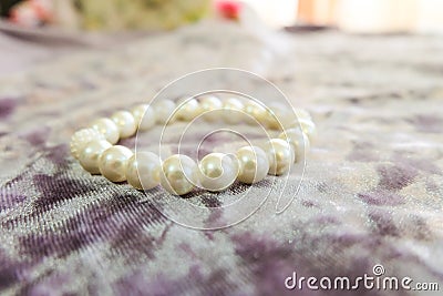 Handmade pearl bracelet on a fabric surface Stock Photo