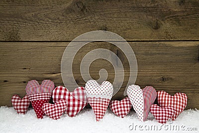 Handmade red white checked hearts on a wooden christmas background. Stock Photo