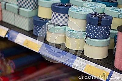 Handmade round paper boxes on the shelf in the supermarket. Wide range of different gift boxes. Stock Photo