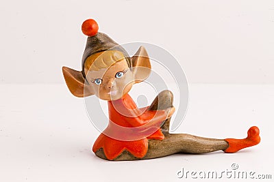 Handmade sitting elf figurine in red and brown Stock Photo