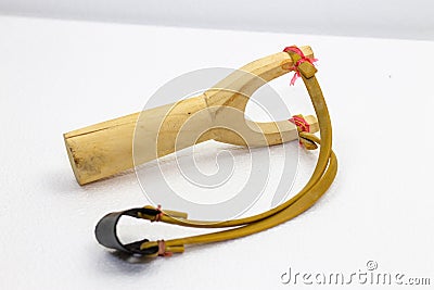 Handmade slingshot catapult. Y-shaped wooden stick with elastic tied between two top parts. Slingshot or Catapult is device for Stock Photo