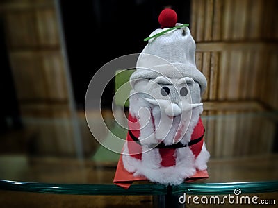 Handmade small statue of Santa Claus for home decoration on the Christmas. Cute old hand made santa with copy space. Stock Photo