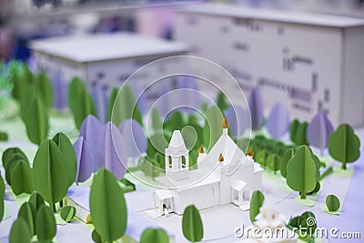 Handmade small white cardboard church and trees Stock Photo