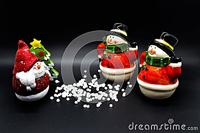 Handmade snowmen figurines isolated on black background. Christmas decoration. Stock Photo