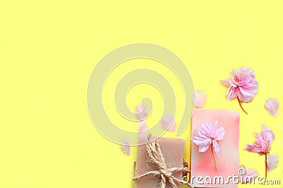 Handmade soap on a yellow background, flower petals.Space for a text Stock Photo