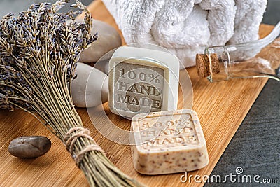 Handmade soaps with lavender bunch and stones on wooden board, product of cosmetics or body care Stock Photo