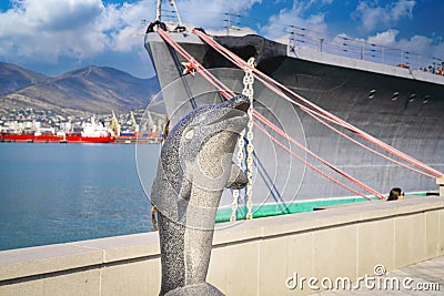 Handmade stone dolphin statue near the sea Stock Photo