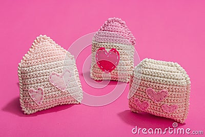 Handmade Valentines Day concept. Creative house figurines, traditional hearts, spring crocheting Stock Photo