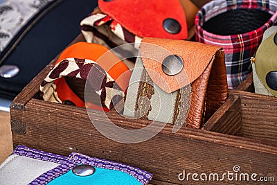 Handmade women's bracelets, made of leather and fabric, with metal rivets, on a store shelf. Fashion accessory. Stock Photo