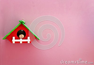 Handmade wood home on pink wall Stock Photo