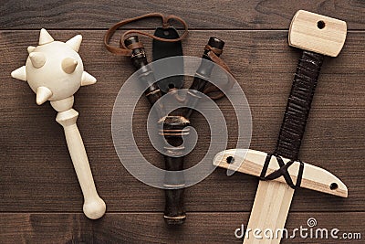 Handmade wooden training toy sword, mace and slingshot Stock Photo