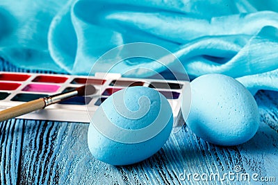 Handmaid blue paint easter egg on table with scarf Stock Photo