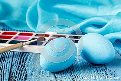 Handmaid blue paint easter egg on table with scarf Stock Photo