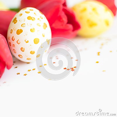 Handpainted eggs with gold design, red tulips against of small stars on white. Happy Easter background Stock Photo