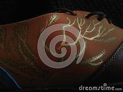 Handpainted golden branches bush, with small green leaves, on a coloured leather custom made dancing shoe Stock Photo